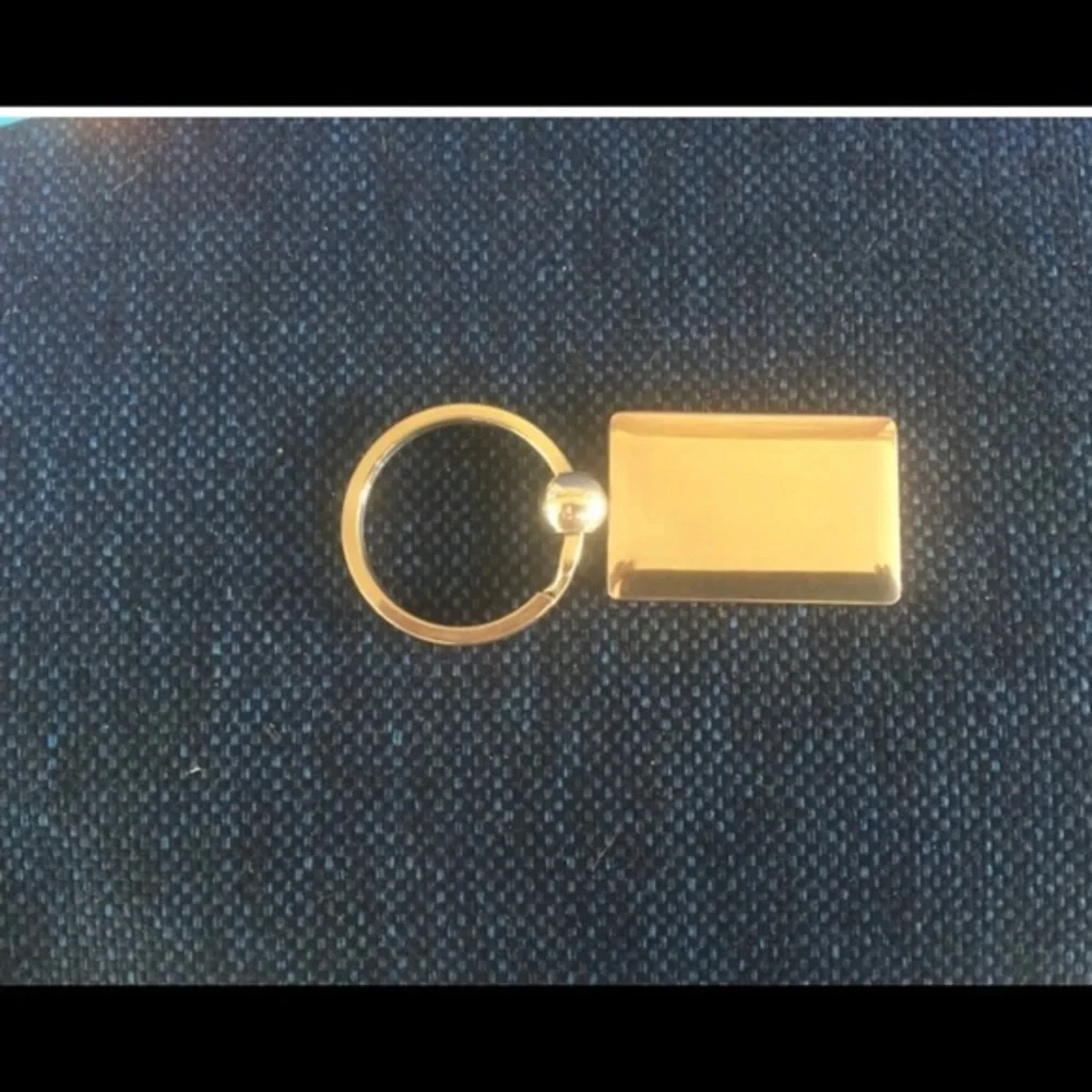 New in Gift Box Silvertone Avon Logo Key Ring